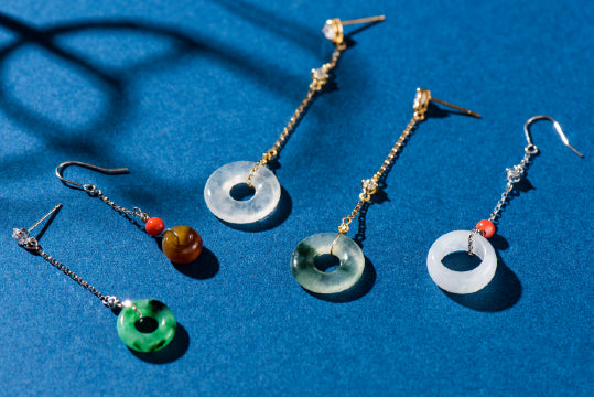 
          
            Different color jade jewelry from Jade artisan on a blue background
          
        