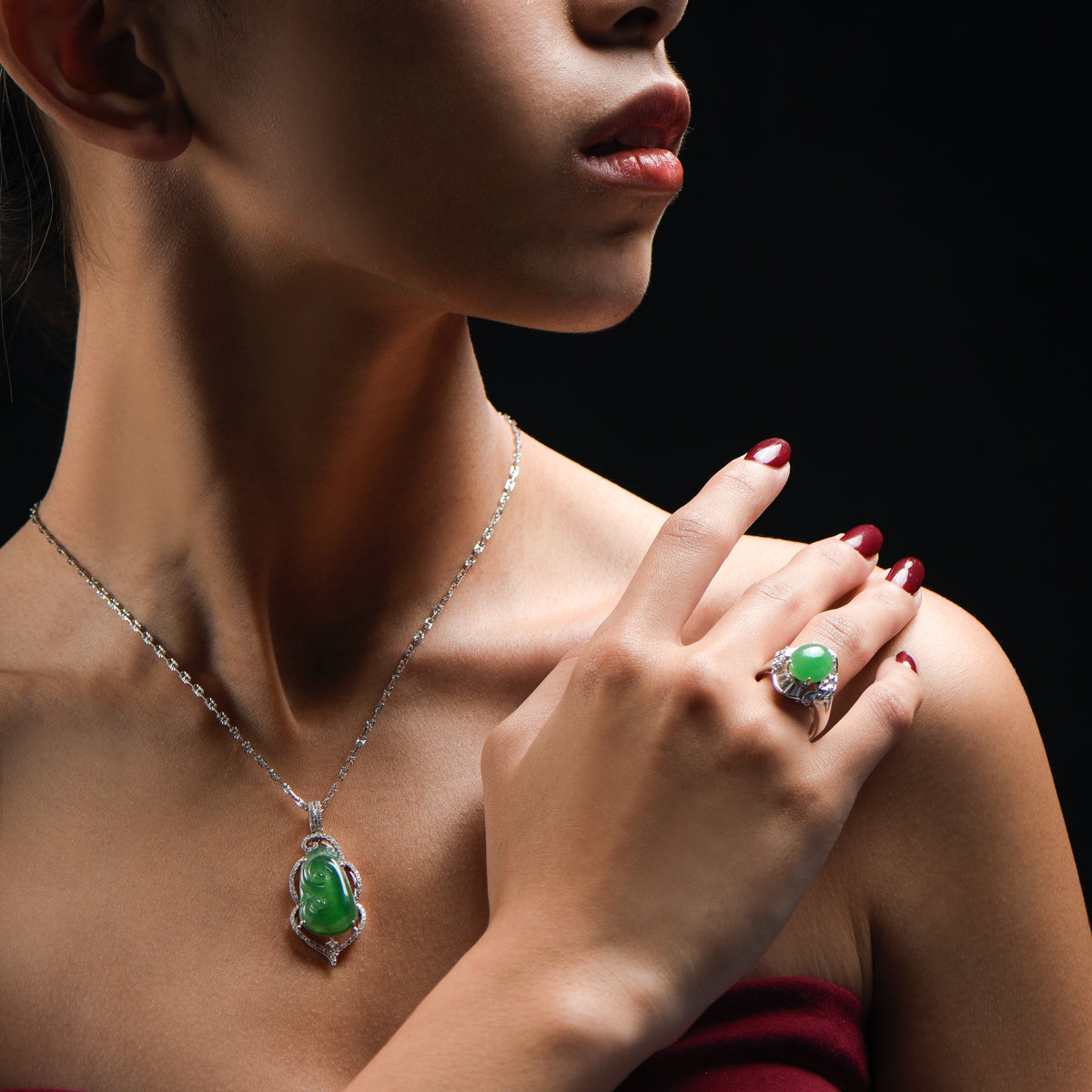 Woman wearing matching green jade pendant and green jade ring