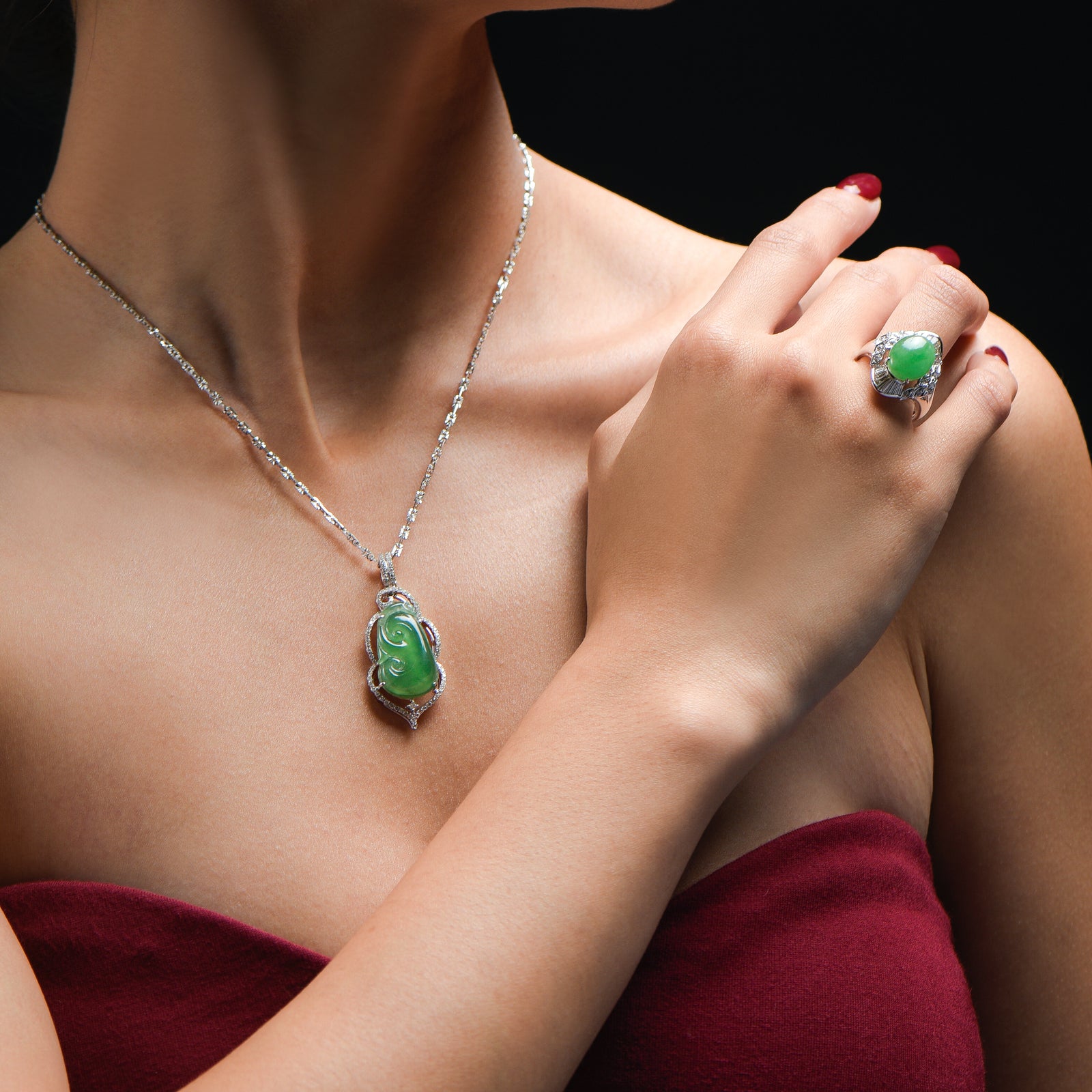 Imperial jade pendant shaped in a Ruyi surrounded by a ring of small diamonds and set on a diamond clasp