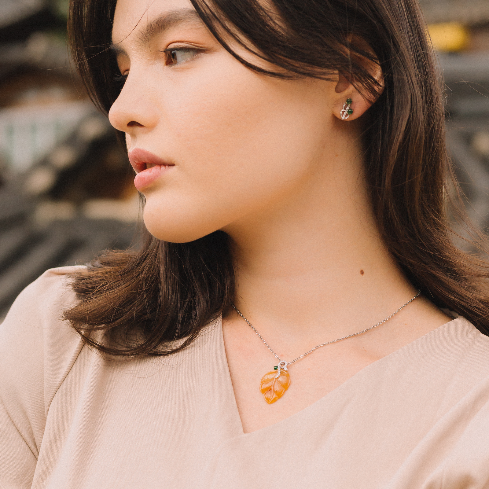 Yellow jade leaf pendant with a deep-green jade orb and diamonds