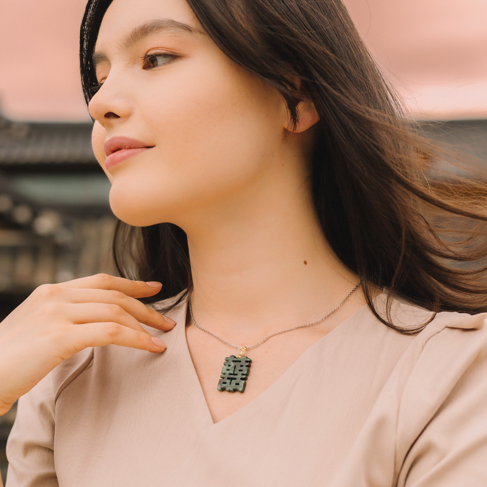 Green jadeite pendant shaped to mean happiness and love