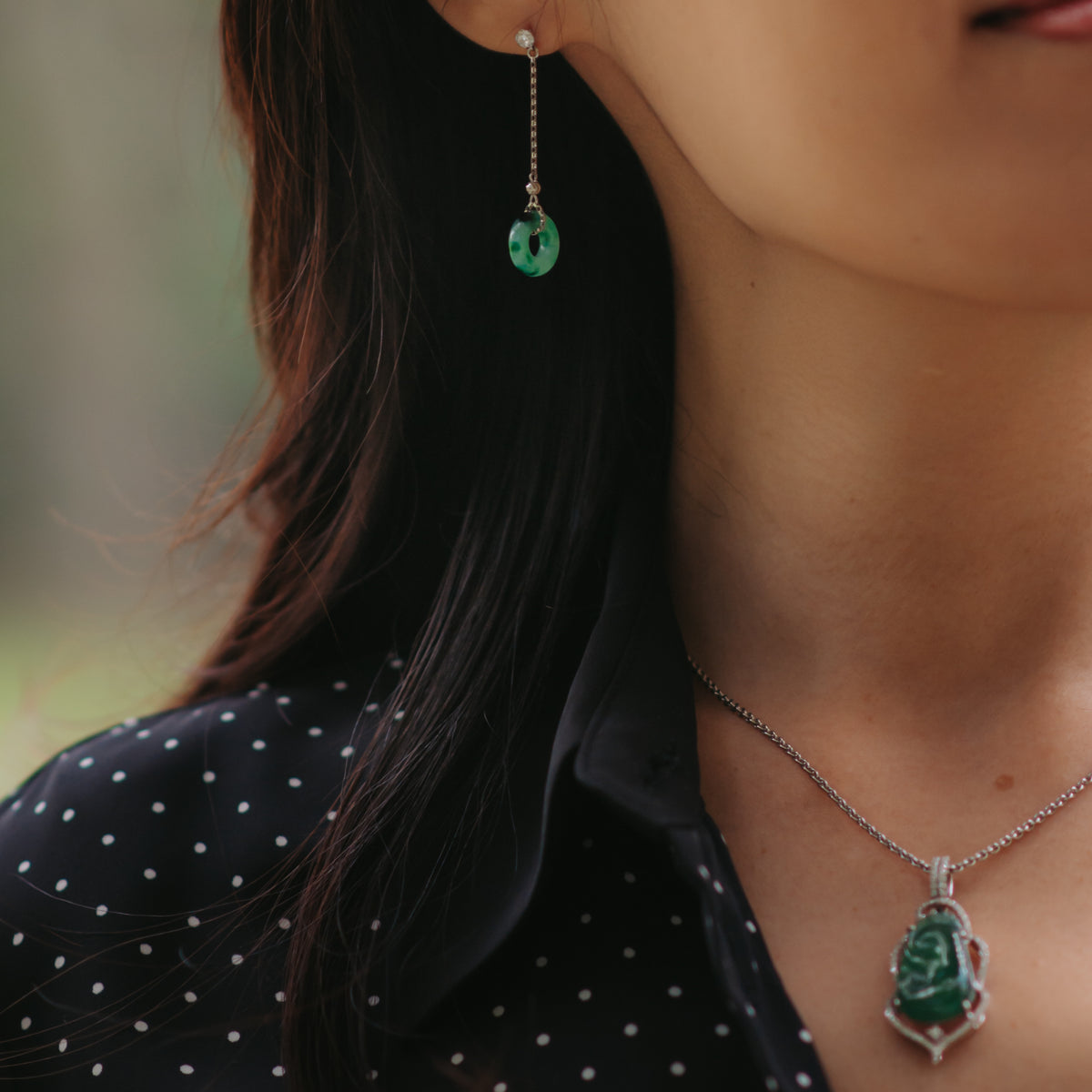 Wearing multiple jade jewelry in a park