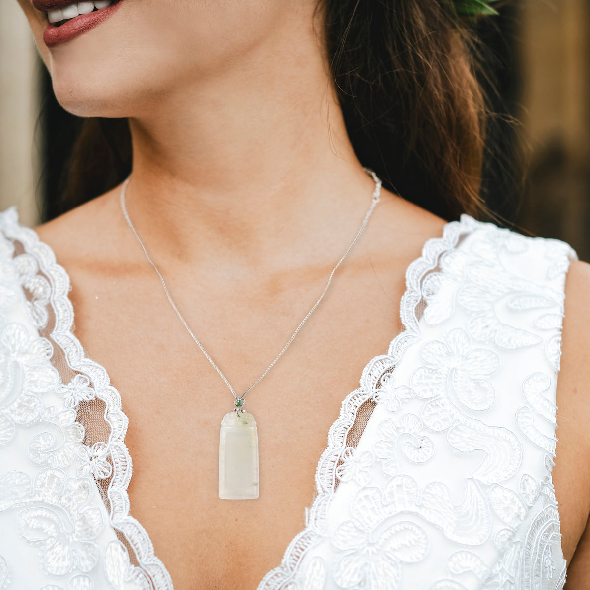 Woman wearing a white jade pendant