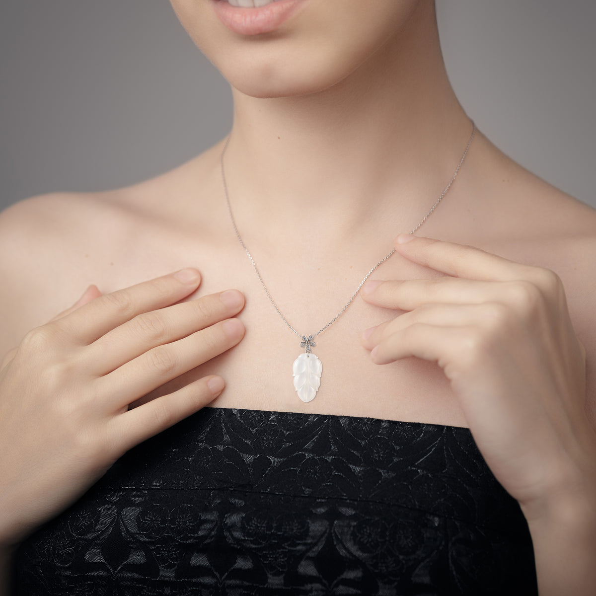 Lady wearing lucky white jade pendant