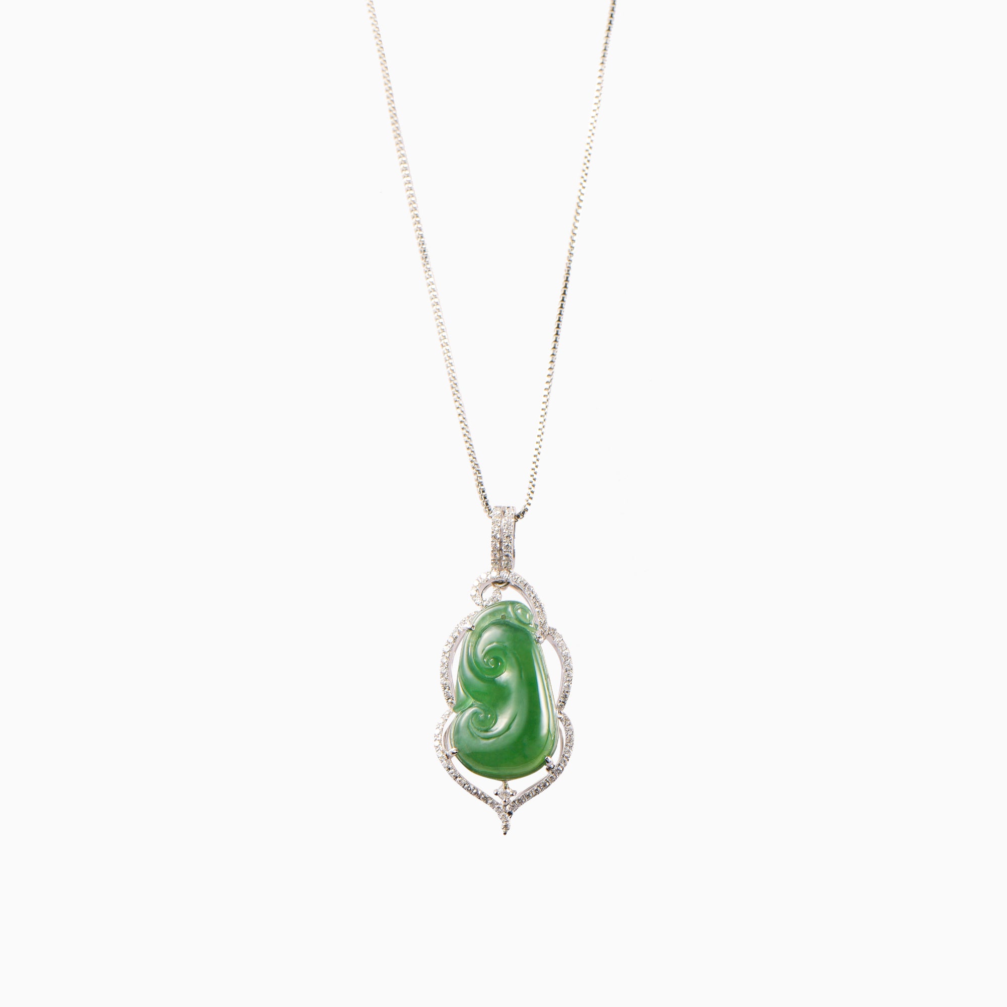 Imperial jade pendant shaped in a Ruyi surrounded by a ring of small diamonds and set on a diamond clasp